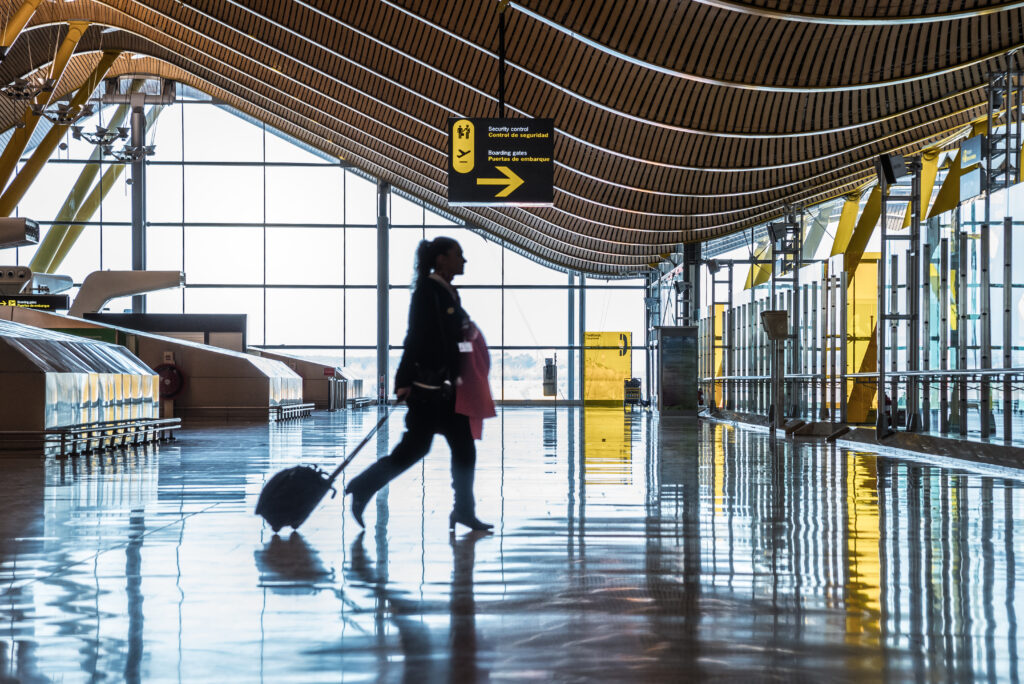 airport terminal with people moving silhouettes and sunray