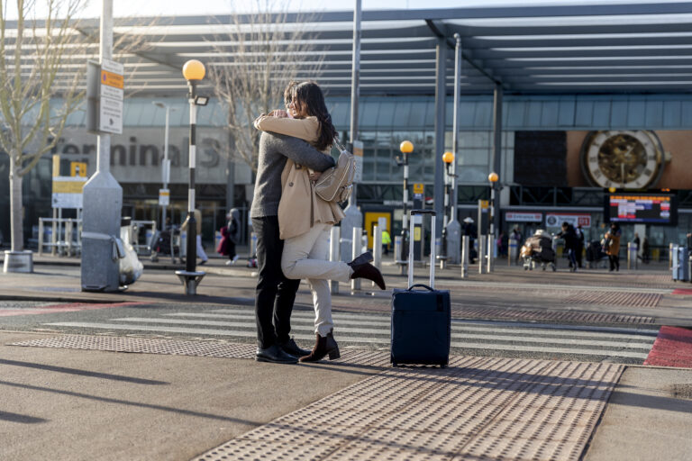 full shot couple hugging outdoors